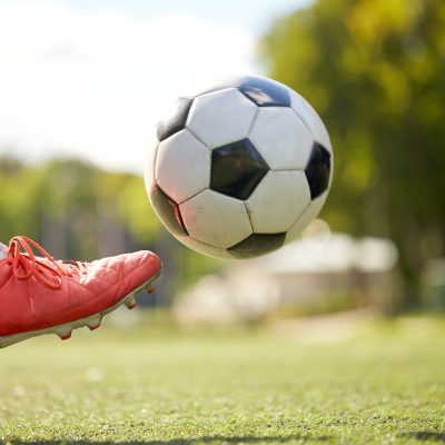 soccer player playing with ball on football field soccer player playing with ball on football field